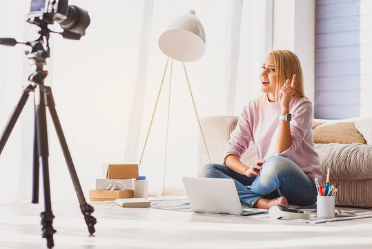 Blond girl recording video for blog