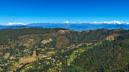 Fototapeta na wymiar Panoramic view of Nepal with green valley and Himalayas snow peaks at the background