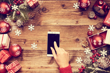 Woman using a touch screen smart phone, hands close up, top view
