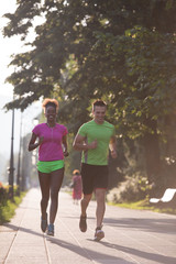 young multiethnic couple jogging in the city