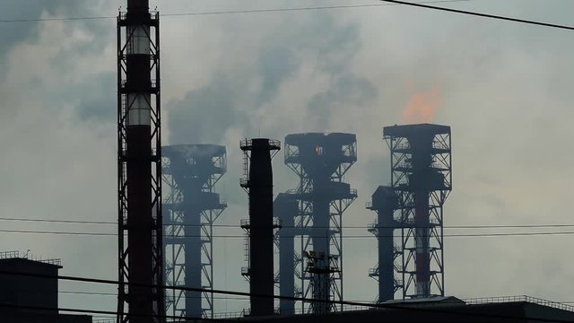 Emissions from the chimneys of the plant, flames and toxic fumes pollutes the environment, 4k
