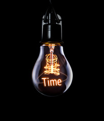 Hanging lightbulb with glowing Time concept.