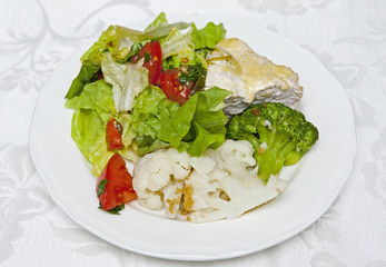 Meat with vegetables on the white plate