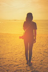 Blurry female photographer on the beach , film tone