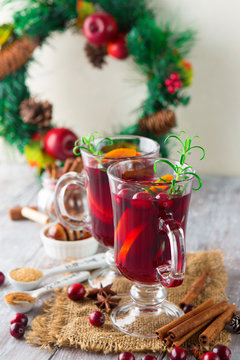Christmas Hot mulled wine in glasses with orange slices, cranberry, anise and cinnamon sticks
