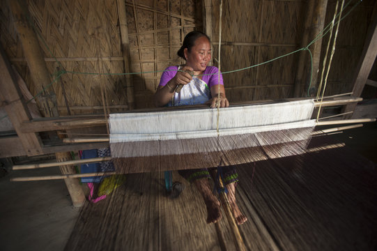 Weaving a Punin on a traditional hand loom, Assam
