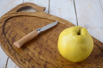 apple quince and knife  on a wooden background. Rustic style