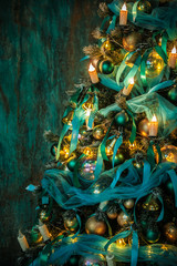 Green New Year tree decorated with toys and balls. Christmas background with grunge plaster wall