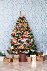 Merry christmas and new year background. Classic green tree decorated with presents under