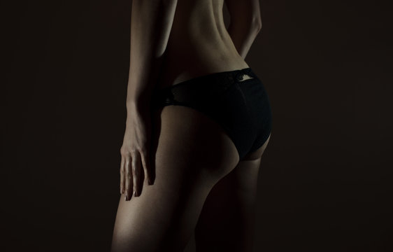Sexual female buttocks in black panties.