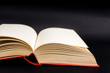 Vintage old open book on black background