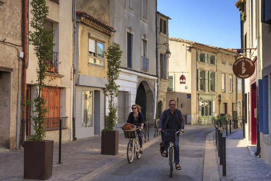 Fototapeta Cyclists in a Ville Basse narrow street, Carcassonne, Languedoc-Roussillon, France