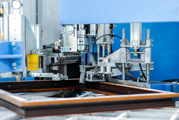 Automatic corner cleaning machine for PVC windows and doors sections with a window