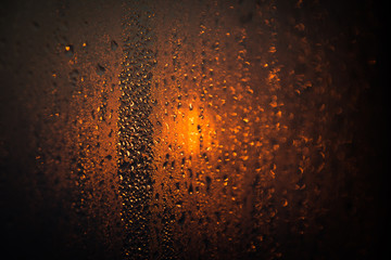 The drops on glass bokeh background. Golden Sunset.