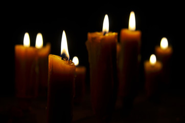 Antique candle burning in a dark room. Christmas Eve, divination, yuletide. Christmas backgrounds. holiday rituals, religion, spirituality, zen. space for text, close-up, copy space