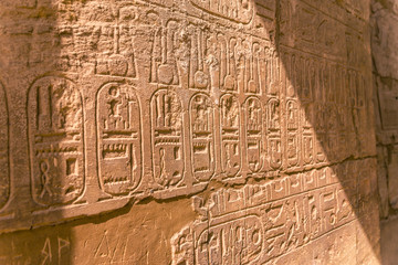 LUXOR, EGYPT: Ancient ruins of Karnak temple in Egypt at noon. The complex is a vast open-air museum, and the second largest ancient religious site in the world