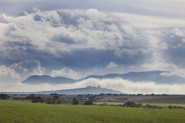 scenery of cereals fields and little town with castle between th