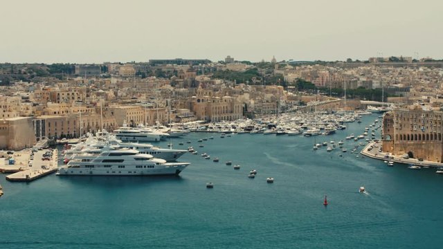 VALLETTA, MALTA - July 1st 2016: view over the bay of Grand Harbour from the Upper Baraka Gardens on war museum to the older UNESCO protected historic skyline of Senglea, Birgu and Kalkara.