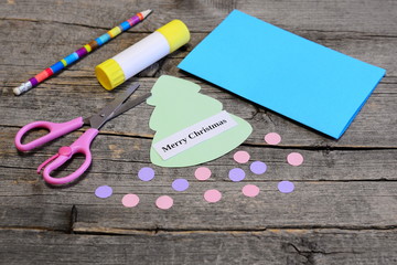 Making a Christmas greeting card. Step. Christmas tree and balls ornaments cut of colored paper,...