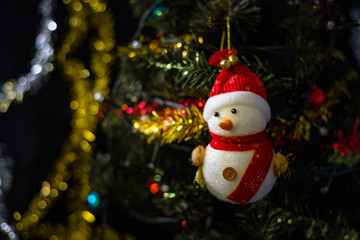 close up soft focus snowman on blurry christmas tree backgroud
