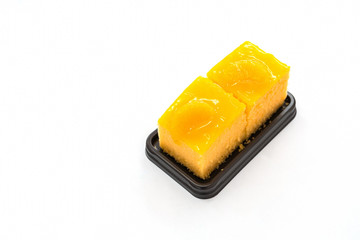 Triple orange cake sliced on white background for copy space
