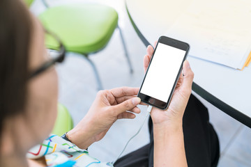 Business concept with BLANK SCREEN mobile phone. Woman with modern mobile phone in hands
FEMale hand holding black cellphone WITH SCREEN FOR COPY SPACE