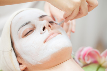 Facial mask.Beautiful young girl relaxing at spa ,getting skin treatment