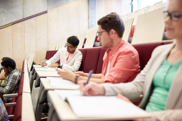 group of students with notebooks in lecture hall