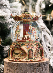 Christmas decoration carousel horses, Christmas presents on wooden table.