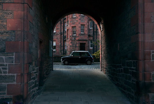 Parked car seen through archway