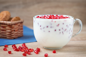 Yogurt and pomegranate seeds in a clear сup