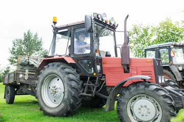 senior man driving tractor at farm