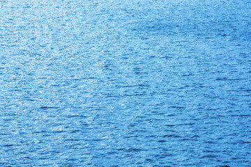 Sea ripples. Bright blue background. Shallow waves on the water.