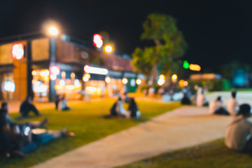 blurred people dinner at park with festive lights for background