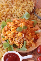 Fried macaroni with sausage and tomato sauce.