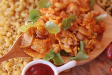Fried macaroni with sausage and tomato sauce.