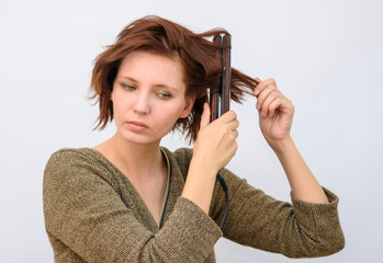 Girl wind the hair on the curling hair curlers