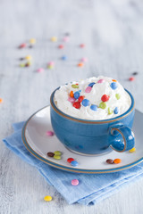 coffee with whipped cream and colorful chocolate drops