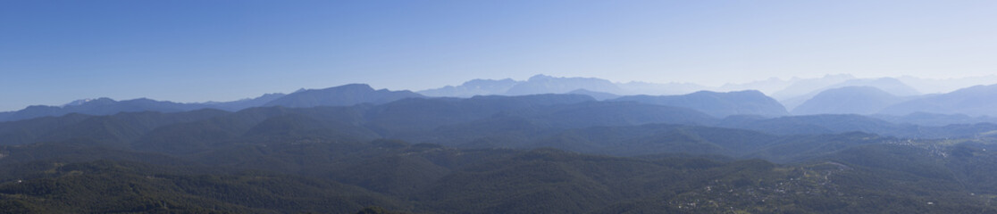 Fototapeta premium Panoramic views of the Caucasus Mountains with an observation tower on the mountain Big Ahun, Krasnodar region, Russia