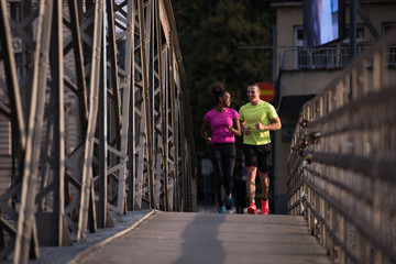 Fototapeta na wymiar multiethnic couple jogging in the city