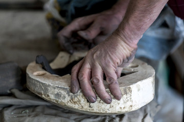 Craftsman making pottery. Hands.
