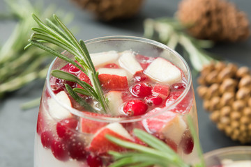 Christmas sangria with cranberries, apples and rosemary