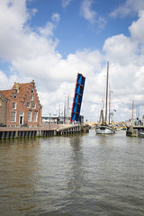 Noorderhaven canal with boats, open bridge and houses in historic old town of Harlingen, Friesland, Netherlands