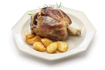 pork shank with roasted potatoes, stinco di maiale con patate arrosto, italian cuisine isolated on white background
