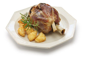 pork shank with roasted potatoes, stinco di maiale con patate arrosto, italian cuisine isolated on white background
