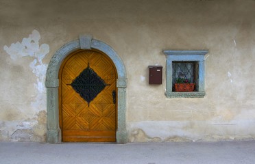 Wall of medieval house in small alpine village in Italy