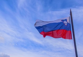 Slovenian national official flagon blue sky background