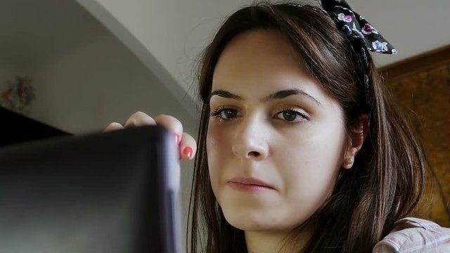 young cute woman is talking with her boyfriend in video chat: webcam, facebook 