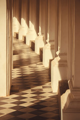 warm sunlight shines through a balcony house on the tile floor.