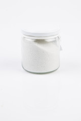 food or lifestyle, glass jar with salt or bath salt isolated in white background